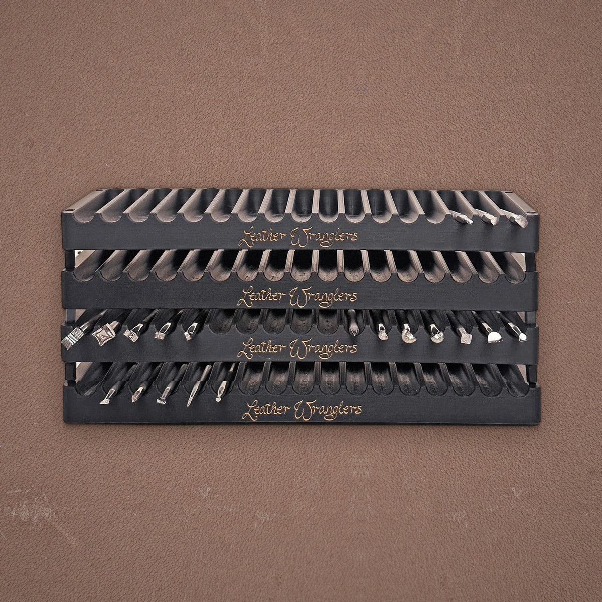 Stacked Leather Wranglers Tools Trays holding stamping tools